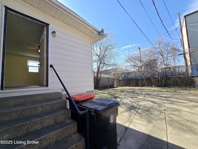 exterior space featuring entry steps and fence