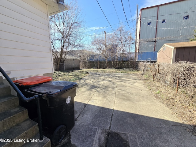 view of patio / terrace featuring a storage shed and fence