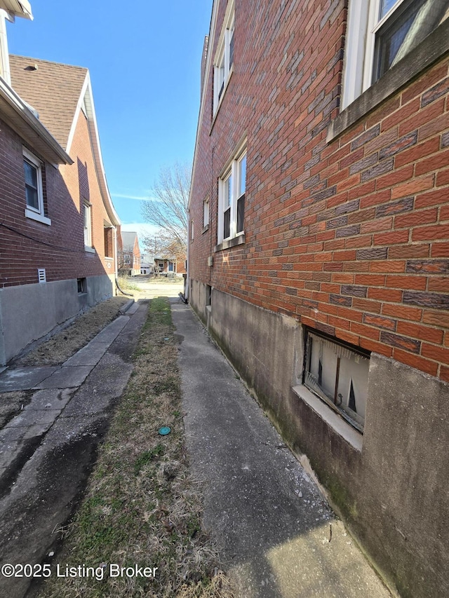 view of side of home featuring brick siding