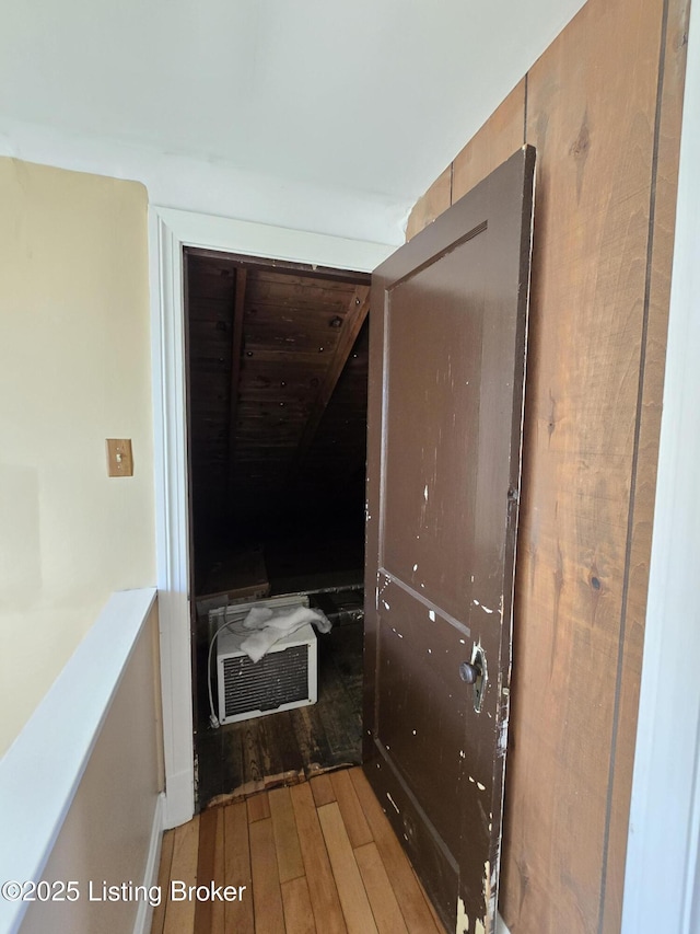 hall featuring a wall mounted air conditioner and wood finished floors