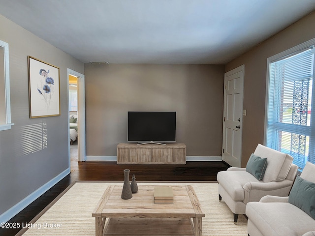 living room featuring dark wood-style floors and baseboards