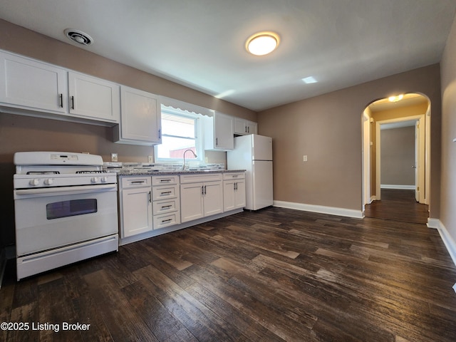 kitchen featuring baseboards, white appliances, dark wood-type flooring, and white cabinets