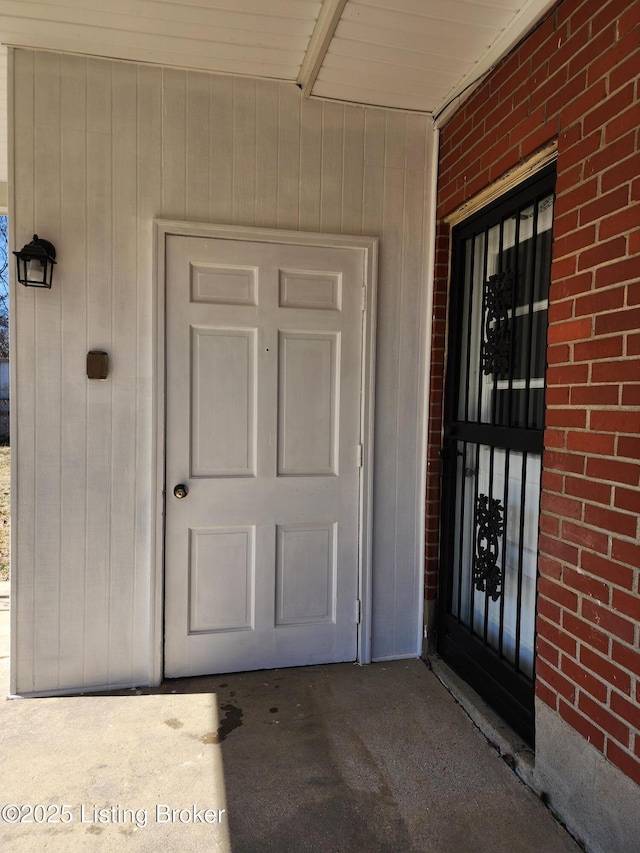 entrance to property with brick siding