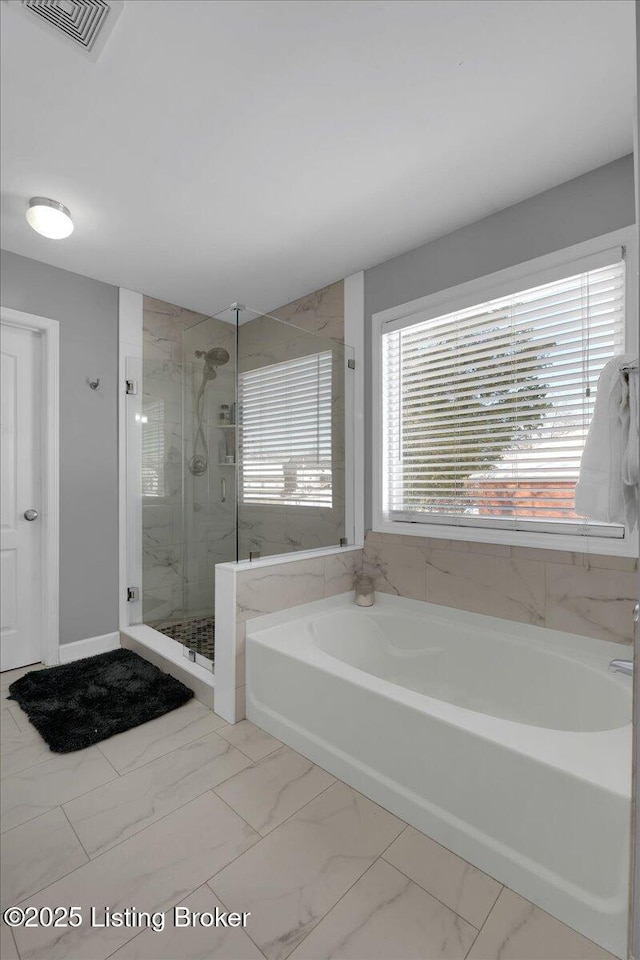 full bath with a stall shower, marble finish floor, visible vents, and a bath