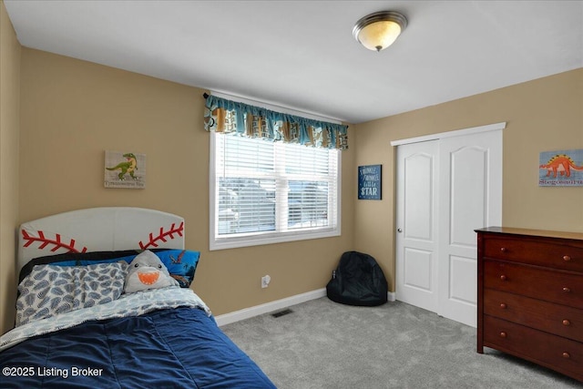 bedroom with baseboards, a closet, visible vents, and light colored carpet