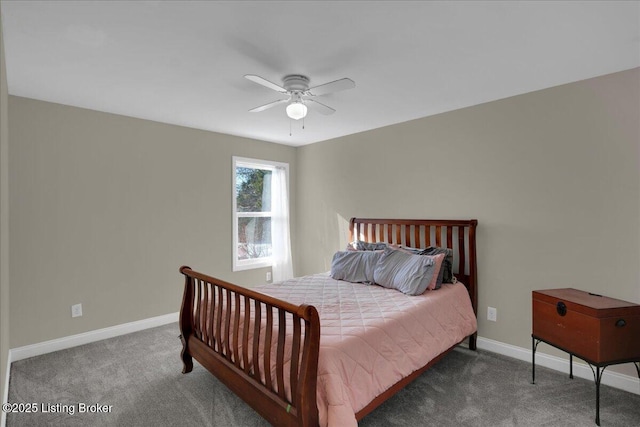 bedroom featuring baseboards, dark carpet, and a ceiling fan