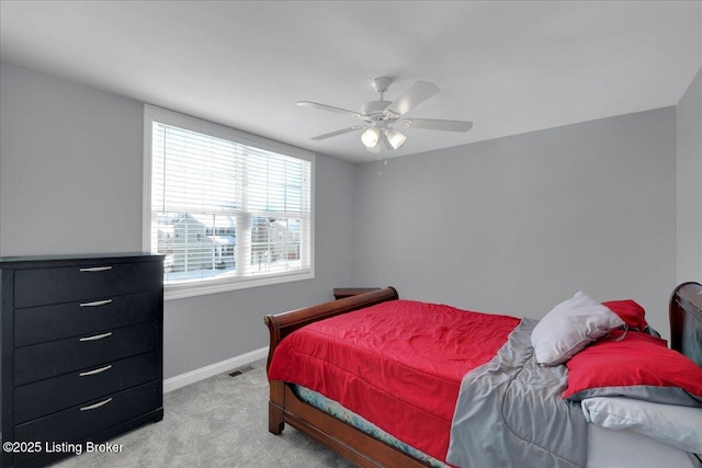 bedroom with light carpet, ceiling fan, and baseboards