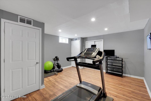 workout area with recessed lighting, visible vents, baseboards, and wood finished floors