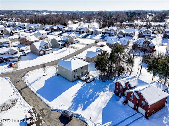 snowy aerial view featuring a residential view