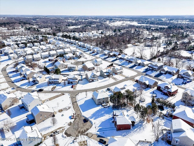 snowy aerial view featuring a residential view