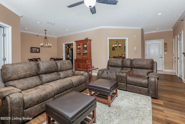 living room featuring crown molding, wood finished floors, and baseboards