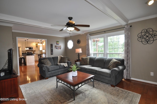 living area featuring baseboards, ceiling fan, wood finished floors, and crown molding