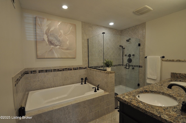 bathroom with a stall shower, visible vents, a garden tub, vanity, and recessed lighting