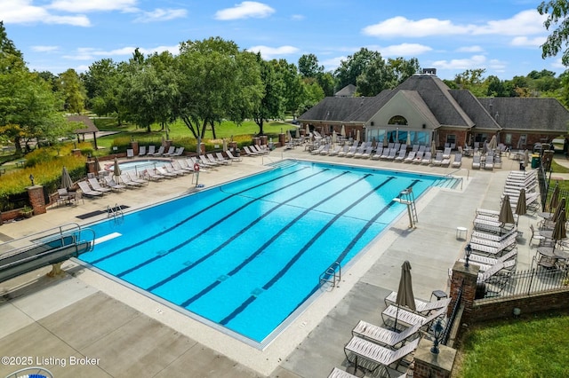 pool with a patio and fence