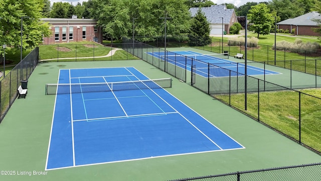 view of sport court featuring a yard and fence