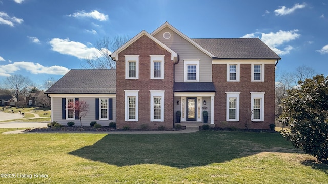 view of front of property with a front lawn, a shingled roof, and brick siding