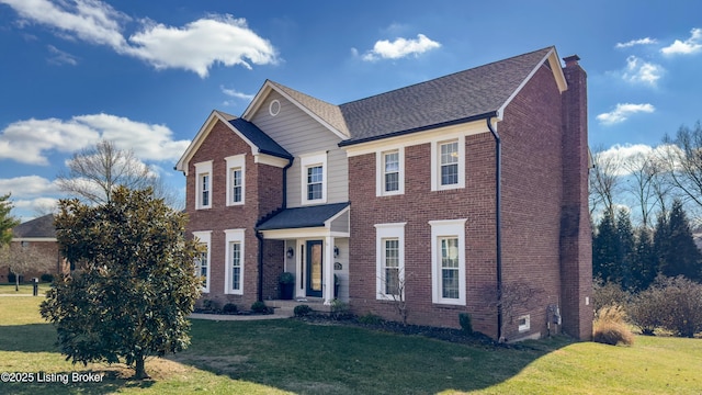 view of front of house featuring crawl space, a front lawn, a chimney, and brick siding