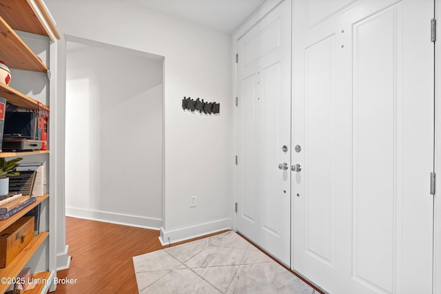 entrance foyer featuring light wood-style floors and baseboards