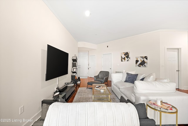 living area with ornamental molding, baseboards, and wood finished floors