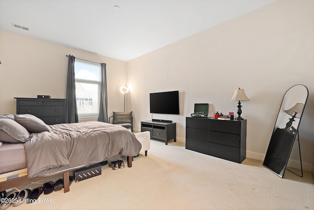 bedroom with baseboards, visible vents, and light colored carpet