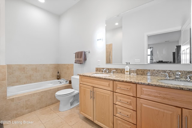 full bathroom with double vanity, a sink, toilet, and tile patterned floors