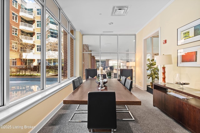 dining room featuring dark colored carpet, visible vents, and baseboards