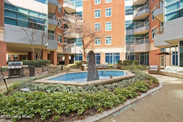 view of pool featuring a grill