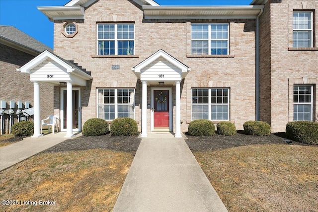 townhome / multi-family property featuring brick siding