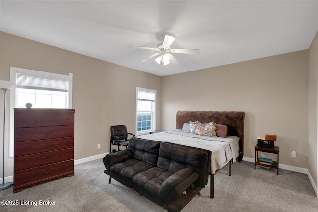 carpeted bedroom featuring baseboards and a ceiling fan