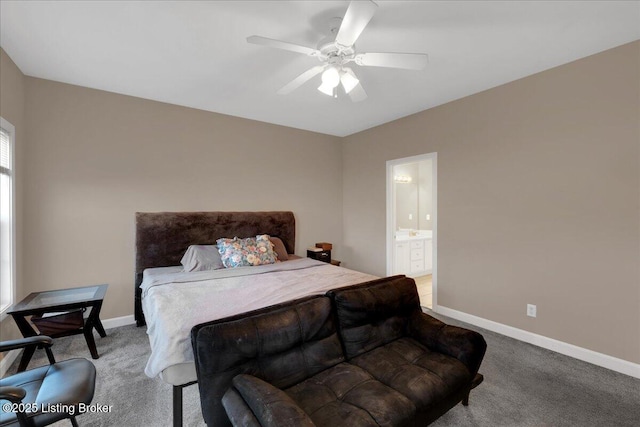 carpeted bedroom featuring ceiling fan, ensuite bath, and baseboards