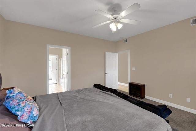 bedroom with light carpet, baseboards, visible vents, and a ceiling fan