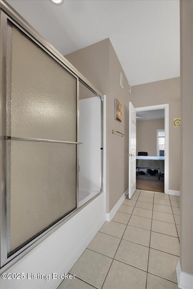 full bath with tile patterned flooring, enclosed tub / shower combo, and baseboards