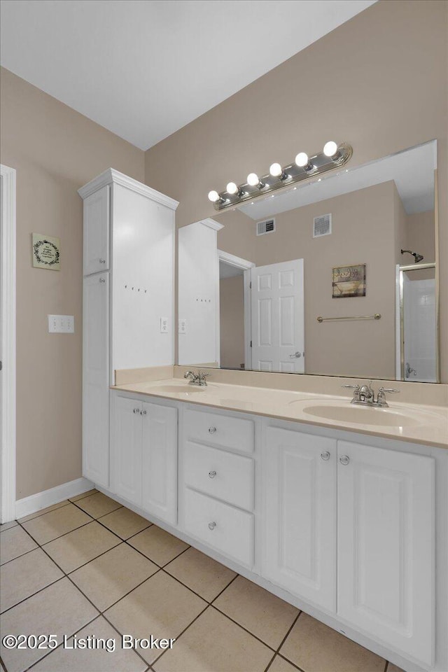 full bathroom with a sink, visible vents, and tile patterned floors