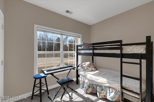 bedroom featuring carpet floors, baseboards, and visible vents