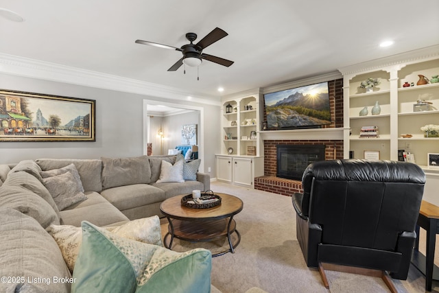 living room featuring a ceiling fan, ornamental molding, carpet, a fireplace, and recessed lighting