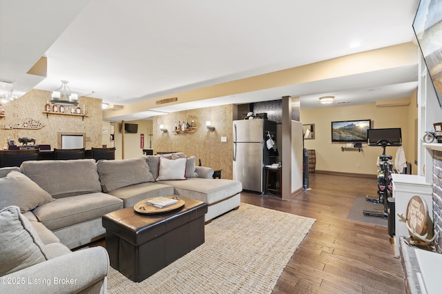 living room featuring baseboards and wood finished floors