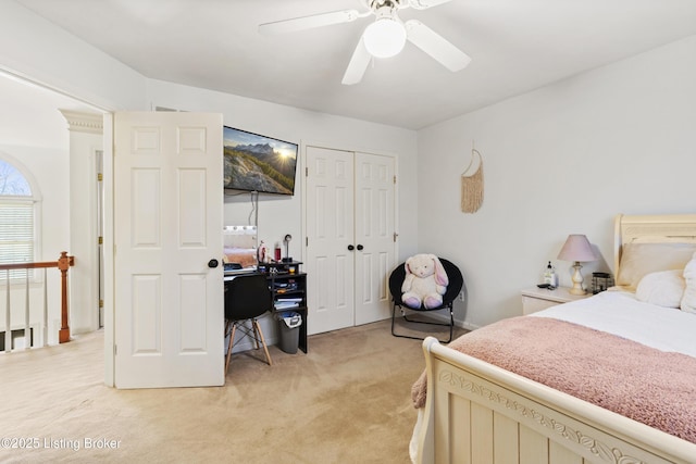 bedroom with a closet, a ceiling fan, and light colored carpet