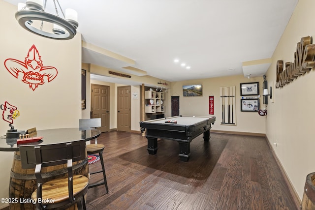 rec room with baseboards, visible vents, and dark wood-style flooring