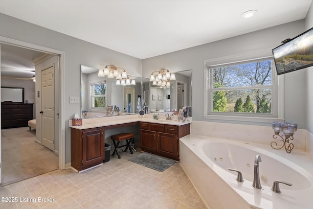 full bath with a tub with jets and vanity