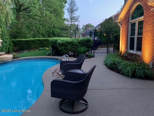 view of pool featuring a patio, fence, and a fenced in pool