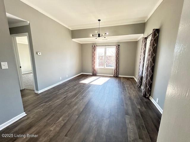 unfurnished dining area with crown molding, dark wood-type flooring, and baseboards