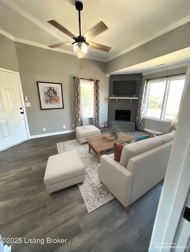 living area with plenty of natural light, wood finished floors, and ornamental molding