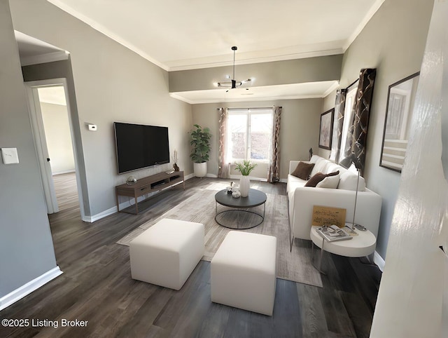 living area with baseboards, wood finished floors, and crown molding