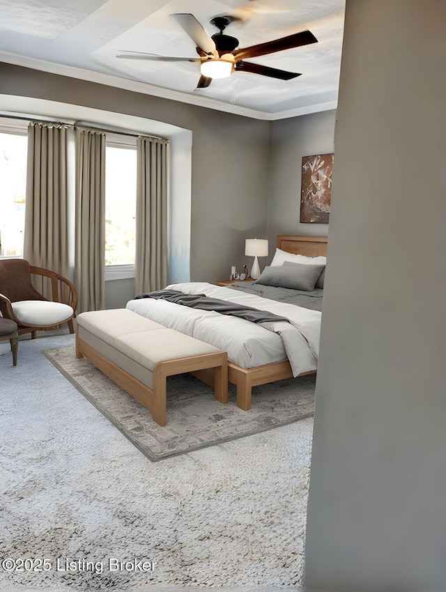 carpeted bedroom featuring a ceiling fan and crown molding