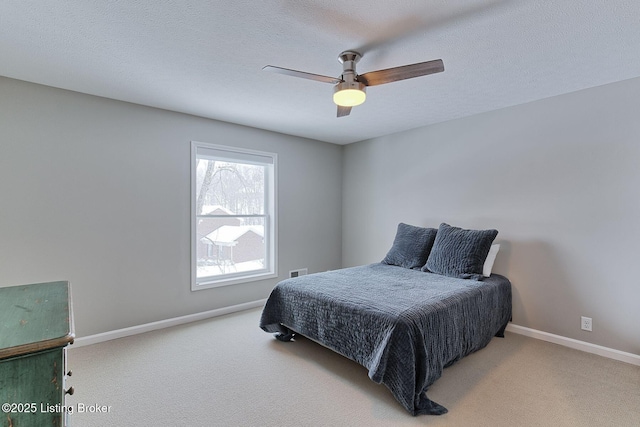 bedroom with carpet floors, a textured ceiling, and baseboards