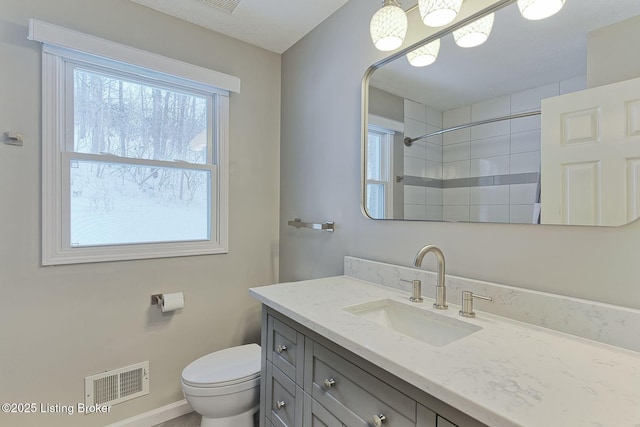 full bathroom with toilet, a shower, vanity, and visible vents