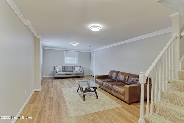 living room featuring light wood-style floors, stairs, baseboards, and crown molding