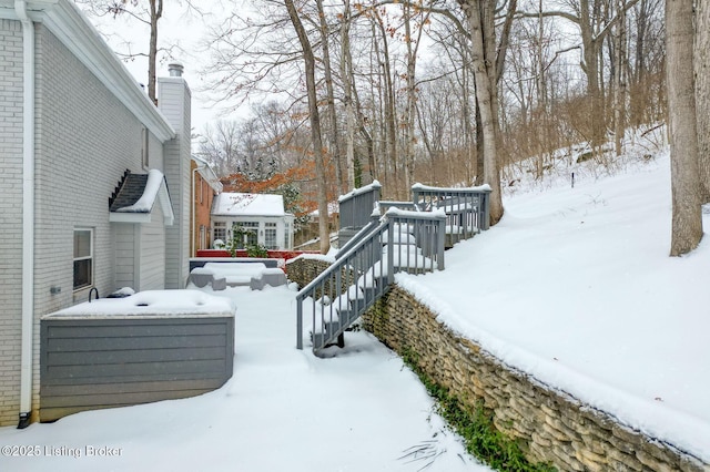 yard covered in snow featuring a deck