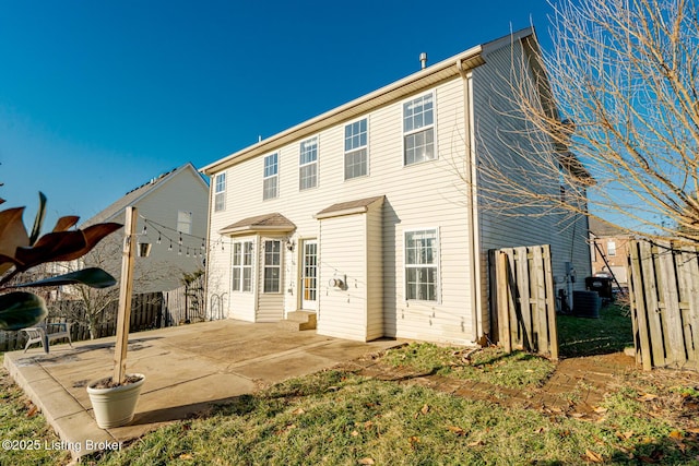 rear view of house with fence and a patio