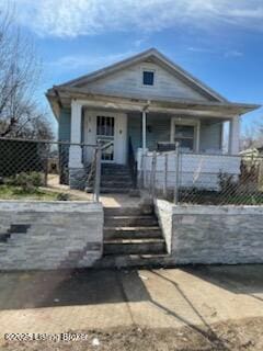 view of front of home featuring covered porch and a fenced front yard